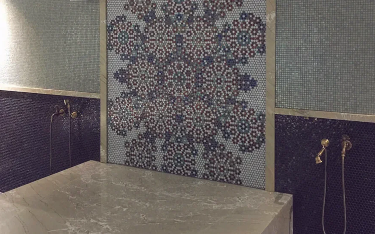 Hammam with stone bench and decorative mosaic walls
