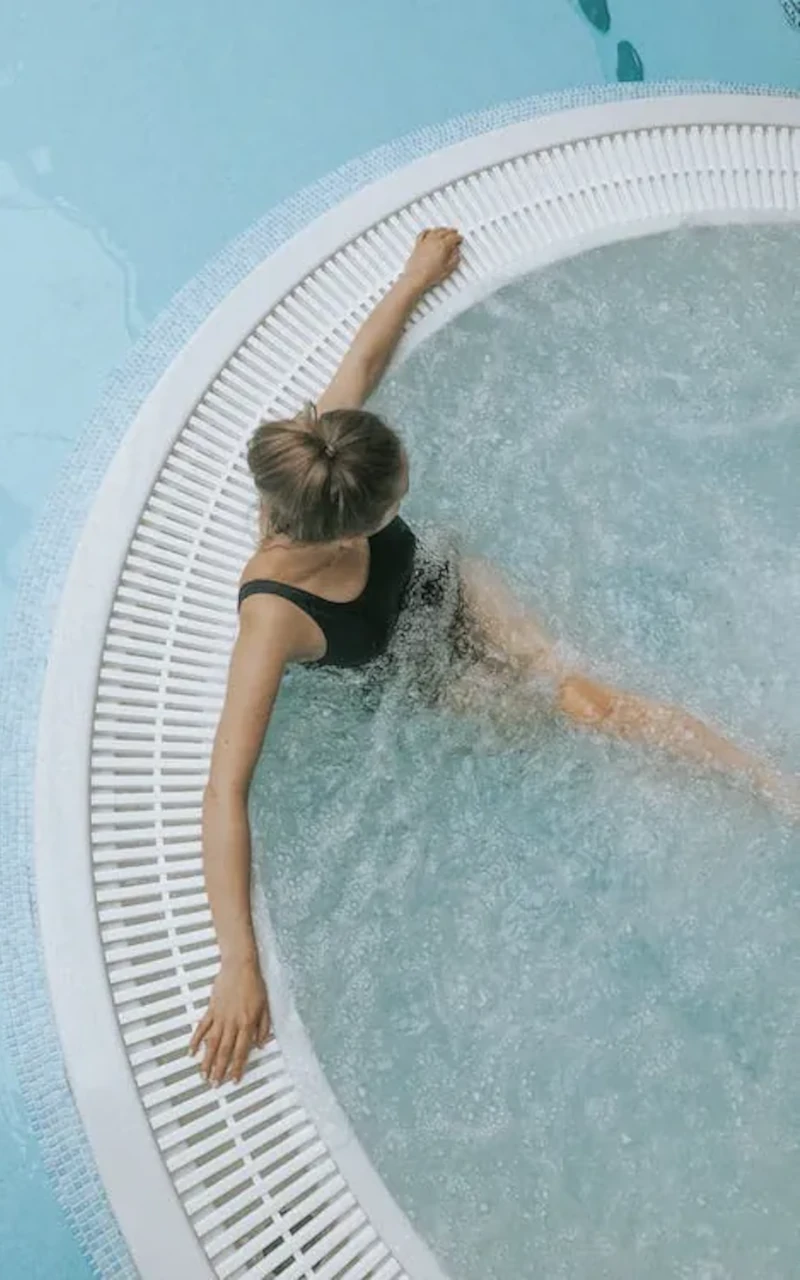 Vue plongeante d’une personne dans un jacuzzi circulaire